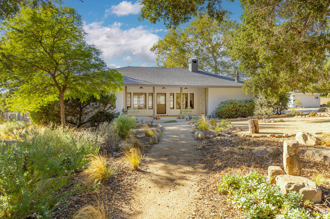 Front view of east end ojai home with oak trees and mature landscaping